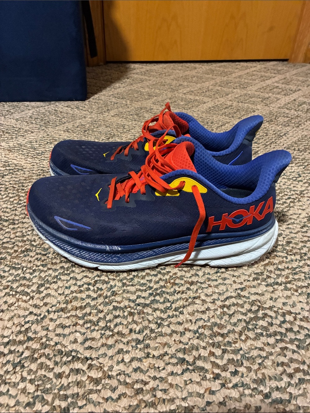 Hoka Navy Blue Running Shoes with Red Laces and Yellow Accents